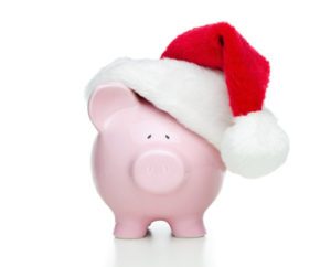 Piggy bank with christmas hat isolated on white background